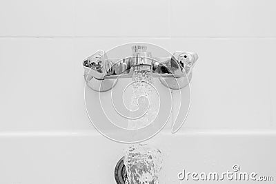 Luxury bath tub and faucet with water. Stock Photo