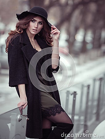 Luxury beautiful woman in black hat, trandy coat and fashion lac Stock Photo