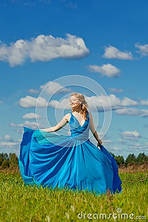 Luxury beautiful woman in long evening fashionable dress outdoor Stock Photo