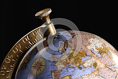 Luxury blue globe spinning in the center of a black background Stock Photo