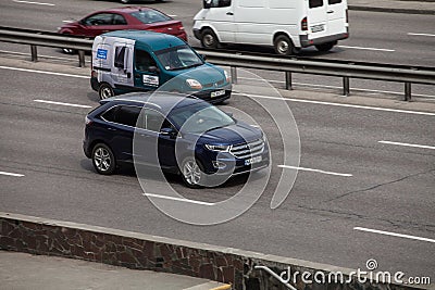 Luxury car blue Ford speeding on empty highway Editorial Stock Photo