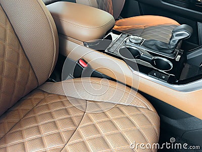 Luxury car brown leather interior. Part of brown leather car seat details with stitching isolated on black. Interior of prestige Stock Photo