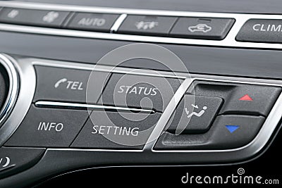 Luxury car inside. Interior of prestige modern car. Black perforated leather cockpit. Media control buttons in black leather with Stock Photo
