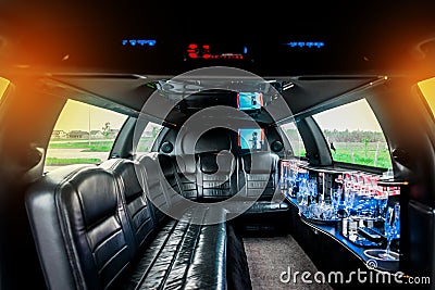 Luxury car interior limousine with black leather seats and a small bar inside the interior of the car Stock Photo