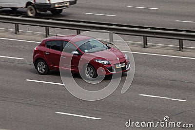 Luxury car red Renault speeding on empty highway Editorial Stock Photo