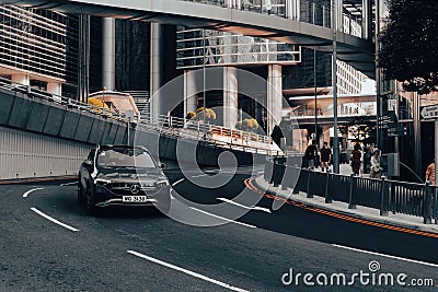 A luxury car turns in a bustling city Editorial Stock Photo