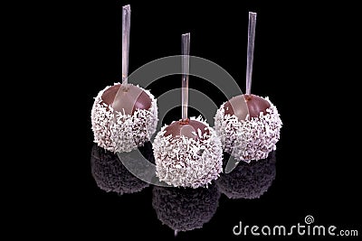 Luxury chocolate balls topped covered with coconuts, with reflection Stock Photo