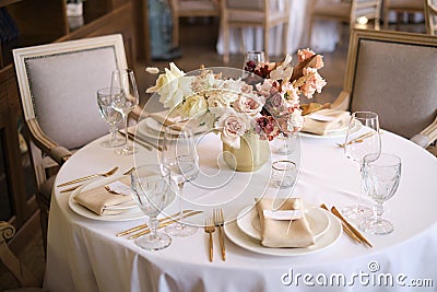 Luxury cozy autumn wedding table decoration in the restaurant. Fresh and dried flowers, roses, carnations. Beautiful table setting Stock Photo