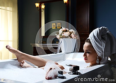 Luxury fashion woman with soft big towel in the evening in hotel Stock Photo