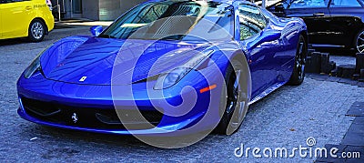 Luxury Ferrari blue car parked at the entrance of the Fairmont Pacific Rim hotel in Downtown Vancouver. Editorial Stock Photo