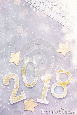 Luxury glitter numbers 2018 in a row with keyboard and presents under snow on grey concrete background Stock Photo