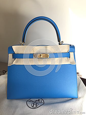 the luxury handbag Hermes kelly size 28 in blue zanzibar color epsom leather and gold hardware Editorial Stock Photo