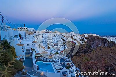 Luxury holiday resort clifftop villas overlooking the Caldera on twilight Santorini Greece Stock Photo