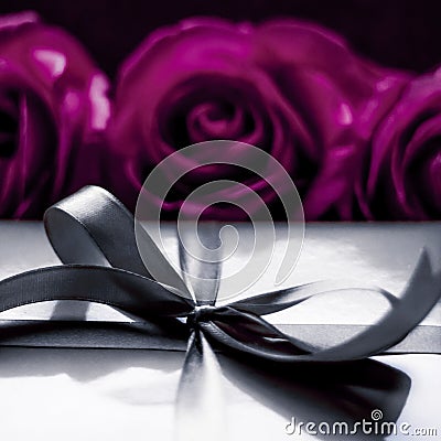 Luxury holiday silver gift box and purple roses as Christmas, Valentines Day or birthday present Stock Photo