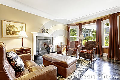 Luxury home interior with fireplace, antique chairs and leather couch Stock Photo