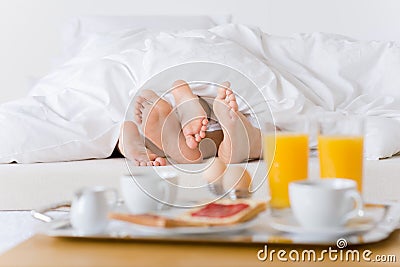 Luxury hotel honeymoon breakfast - couple in bed Stock Photo