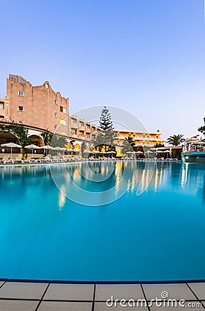 Luxury Hotel Resort with Swimming Poll Illuminated at Sunrise Stock Photo
