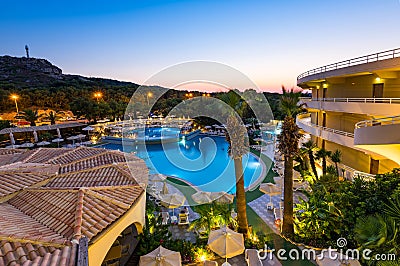 Luxury Hotel Resort with Swimming Poll Illuminated at Sunrise Stock Photo