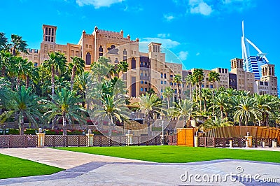 The luxury hotels behind the garden of Souk Madinat Jumeirah market, Dubai, UAE Editorial Stock Photo