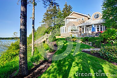 Luxury house exterior with impressive backyard landscape design. Stock Photo