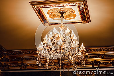 Luxury interior chandelier has light candles. Stock Photo