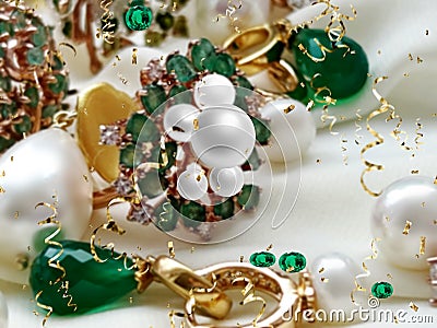 Luxury jewelry Emerald greeen white pearl gold rings and earing jewelry on white background Stock Photo