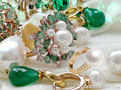Luxury jewelry Emerald greeen white pearl gold rings and earing jewelry on white background Stock Photo