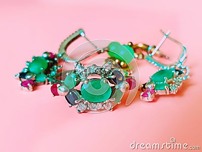 Jewelry green emerald silver pink opal costume jewelry for women on living coral background Stock Photo