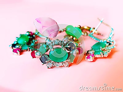 Jewelry green emerald silver pink opal costume jewelry for women on living coral background Stock Photo