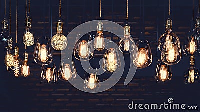 Luxury light bulb hanging decor glowing in dark. Stock Photo