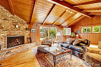 Luxury log cabin house interior. Living room with fireplace and Stock Photo