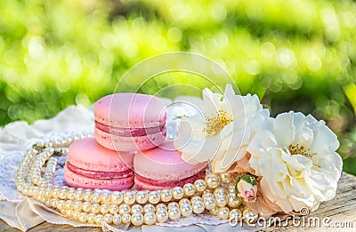 Luxury macaroons and flower. Pink almond macaroon cake. Elegant dessert for beautiful lady. Stock Photo