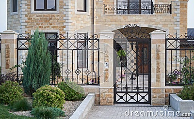 luxury metal forged front door and fence in a private house Stock Photo