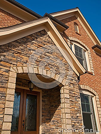 Luxury Model Home Exterior stone arch entrance Stock Photo