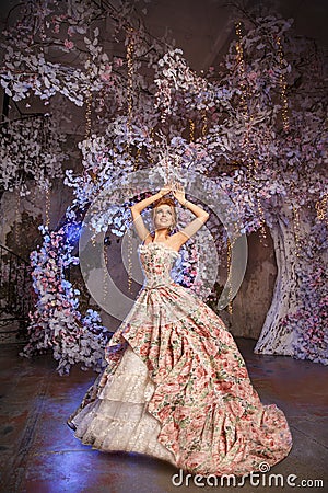 Luxury model in vintage style. Beautiful woman with a stunning hairstyle and make-up in a rococo dress. Girl at the Masquerade Stock Photo