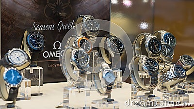 Luxury Omega Seamaster watches on display in store window, shallow depth of field. Editorial Stock Photo