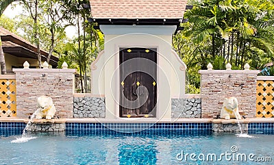 Luxury Outdoor Swimming Pool with Thai Style Decoration and Elephant Water Feature Stock Photo