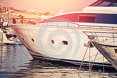 Luxury parked modern motor yacht marina dock in sea sunset Stock Photo