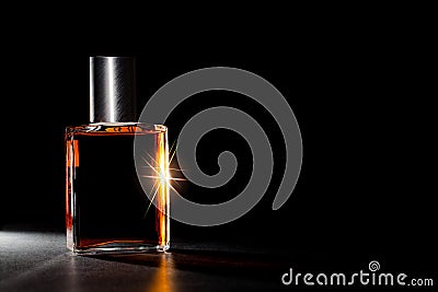 Luxury perfume bottle. Expensive fragrance in the spotlight. Stock Photo