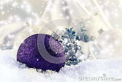 Luxury purple Christmas ball with ornaments in Christmas Snowy Landscape. Stock Photo