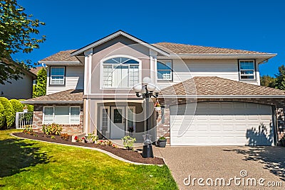 Luxury residential house with grass lawn in front Stock Photo