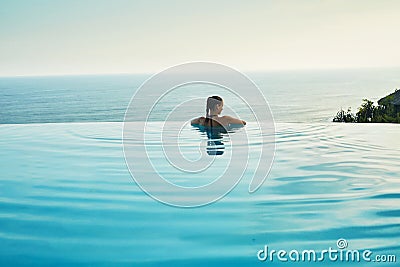 Luxury Resort. Woman Relaxing In Pool. Summer Travel Vacation Stock Photo