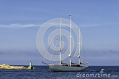 luxury sailing yacht entering a harbour in the Mediterranean Sea Stock Photo