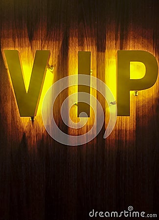 Luxury style big VIP text lights sign with electric bulbs., golden background. Stock Photo