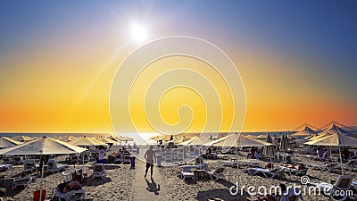 Luxury summer beach resort with straw umbrellas at sunset Editorial Stock Photo