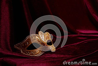 Luxury venetian mask on dark red background. Carnival masquerade fantasy mask Stock Photo