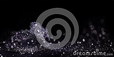 Luxury venetian mask on dark silver bokeh background. New year eve and christmas party celebration design banner. Fantasy carneval Stock Photo