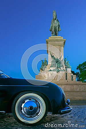 Luxury vintage classic sport car bumper and Monument to Garibaldi in night Rome Editorial Stock Photo