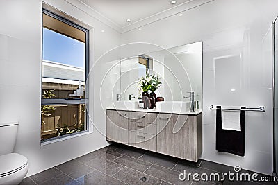 Luxury washroom with a window beside a bowl Stock Photo