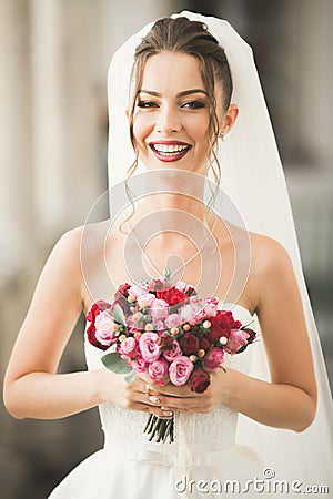 Luxury wedding bride, girl posing and smiling with bouquet Stock Photo